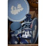 A quantity of blue and white Wedgwood china to include man on the moon plates, various vases,