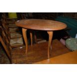 A modern oval Oak Occasional Table with stylised cabriole legs.