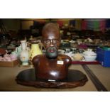 An old carved African hardwood sculpture of Bust, 35 cms tall, on carved wood stand.