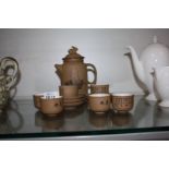 A small Oriental brown pottery Teaset for six, the teapot having a rabbit finial.