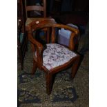 A 1930's Mahogany Tub Chair with curved two piece back rail forming the arms,