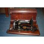 A wooden cased Frontom hand Sewing machine