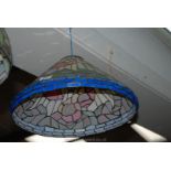 A Tiffany style conical shaped Light-shade depicting stylised flowers and foliage,