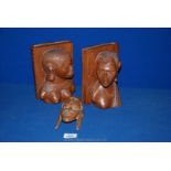 A pair of African carved wood Bookends depicting tribal ladies and a wall hanging mask of similar