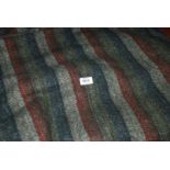 A blue, beige, grey and maroon striped Throw/Travel Rug, having very soft woollen feel,