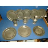 A quantity of antique and vintage Pewter including eight dinner plates, two tankards and a measure.