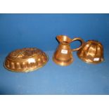 Two Copper Jelly Moulds and a Copper Jug