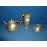 An Arts and Crafts English Pewter Jug marked 0303, with a matching Teapot,