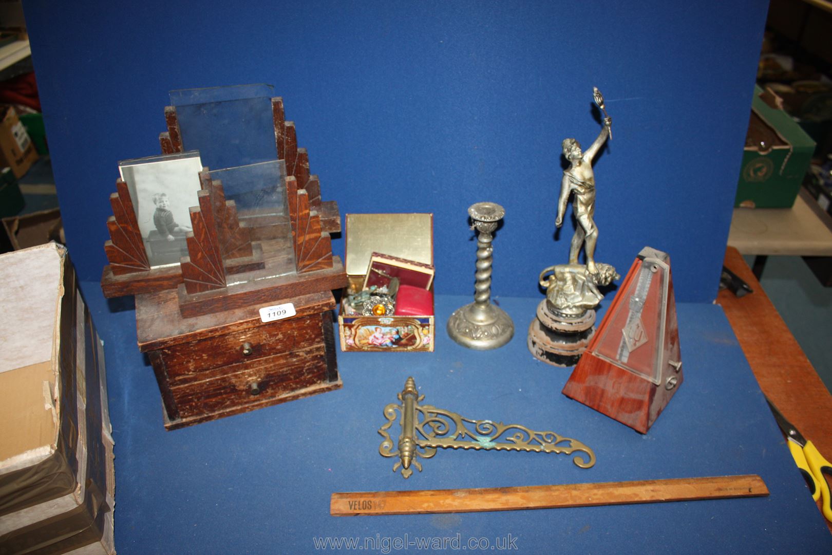 A box of miscellaneous including miniature oak two drawer chest, a modern metronome,