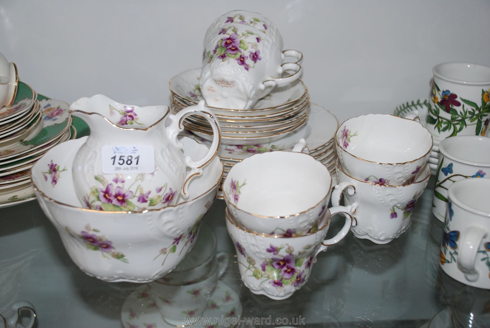 A part Pointons china Teaset decorated with violets including six cups, six saucers,