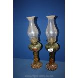 A pair of Oil Lamps with green twisted glass reservoir having base incorporated
