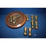 A quantity of brass furniture castors in a treen bowl