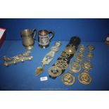 A horse and plough brass hanger, horse brasses, love spoon and two tankards.