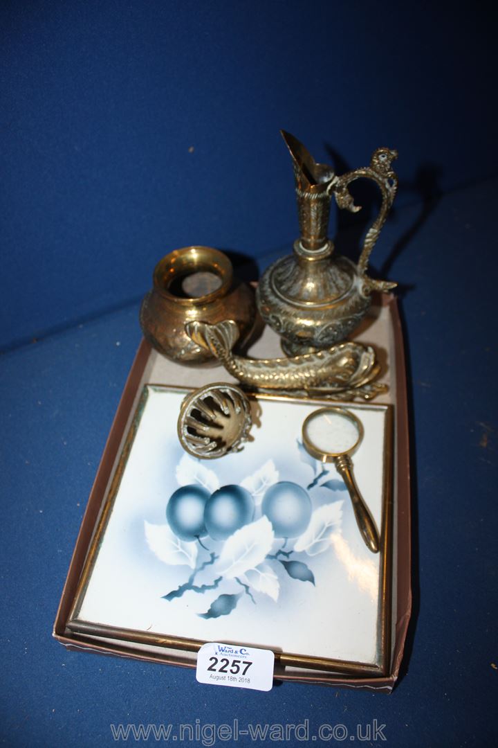 A brass fish door knocker, small brass magnifying glass,