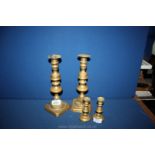 A tall pair of Brass Candlesticks with pushers and a smaller pair of Candlesticks
