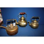Three brass kettles