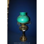 A Brass Oil Lamp with green glass shade