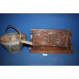A wood hanging wall shelf with carving of a sea creature and a galvanized container