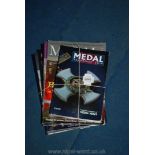 A quantity of medal and collectibles auction magazines and a medal year book 2016.