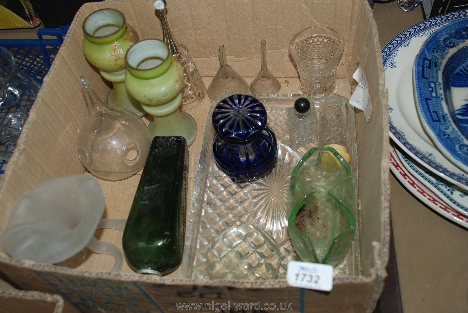 A box of miscellaneous glass including two green vases, green liqueur bottle, funnels, etc.