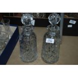 A pair of bottled shaped decanters including stoppers.