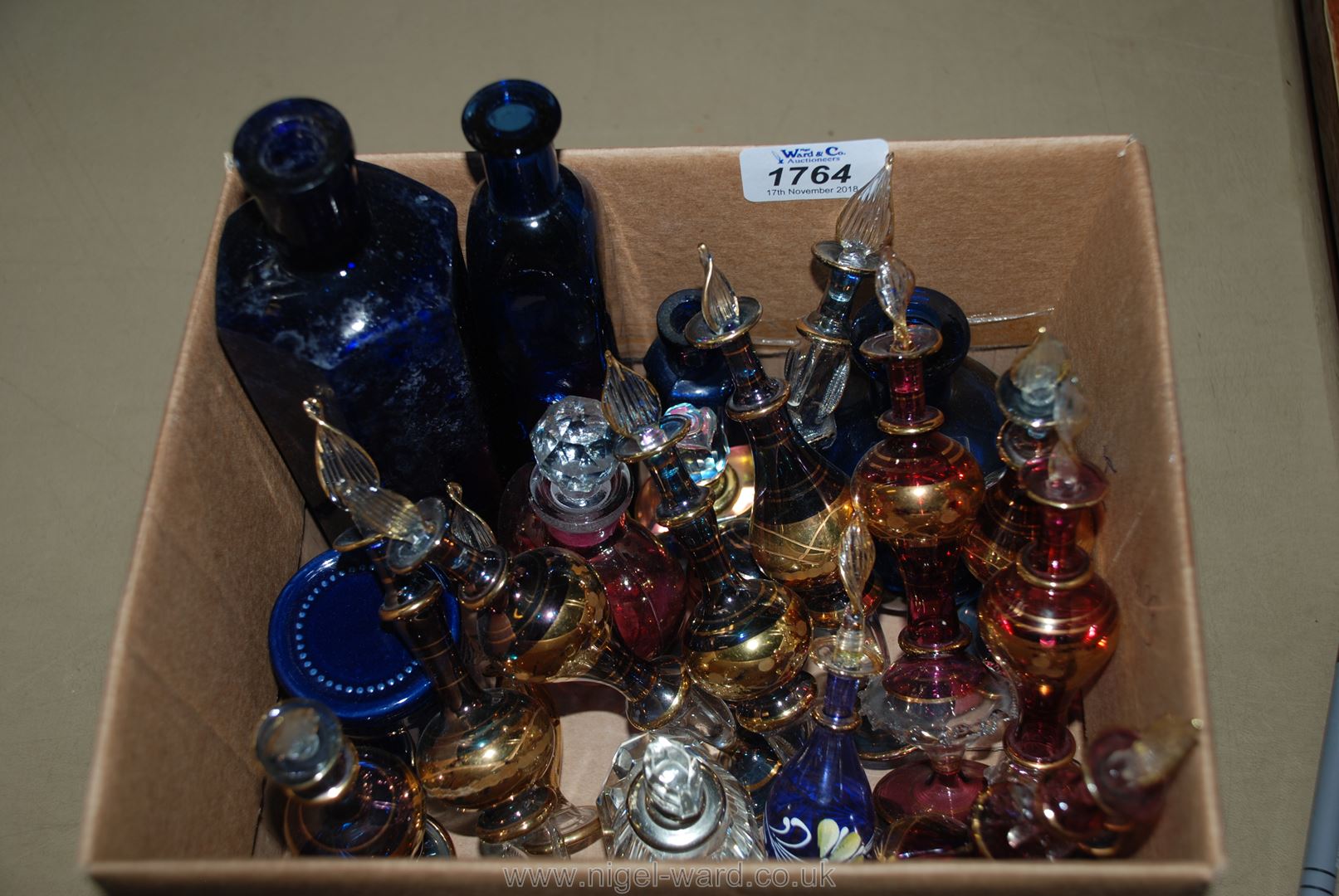 A box of assorted coloured glass Perfume Bottles including red/pink perfume bottle,