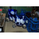Two blue and white studio glass Vases standing on three clear glass feet, signed Ingrid Pears.