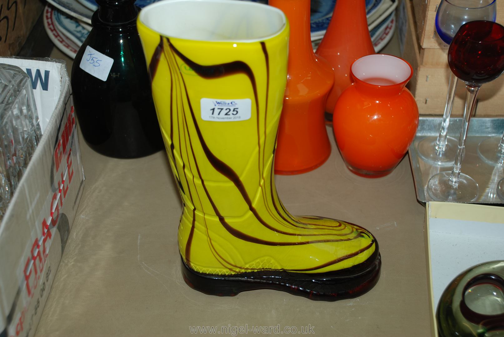 A yellow art glass wellington Boot with Laguna label attached.