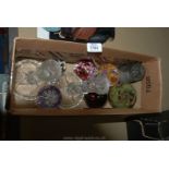 A box of glass including two cut crystal glass candle sticks, assortment of paper weights,