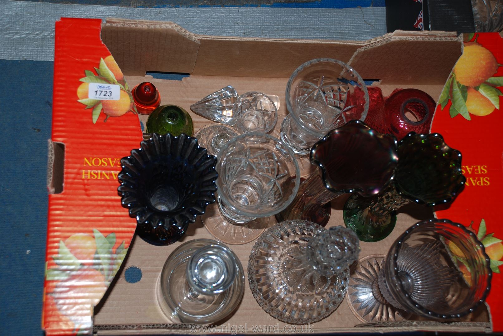 A quantity of glass including two decanters with stoppers, a pair of footed vases, paperweights,