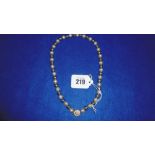 A BLACK AND WHITE PEARL NECKLACE WITH 14CT GOLD CLASP