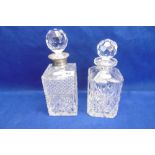 A CUT CRYSTAL DECANTER WITH SILVER COLLAR AND ONE OTHER