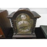 A LARGE OAK MANTLE CLOCK