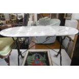 AN IRON AND MARBLE TOP TABLE