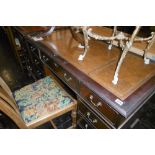 A MAHOGANY LEATHER TOPPED DESK