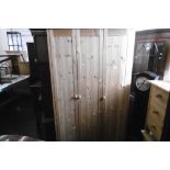 A PINE THREE DOOR WARDROBE