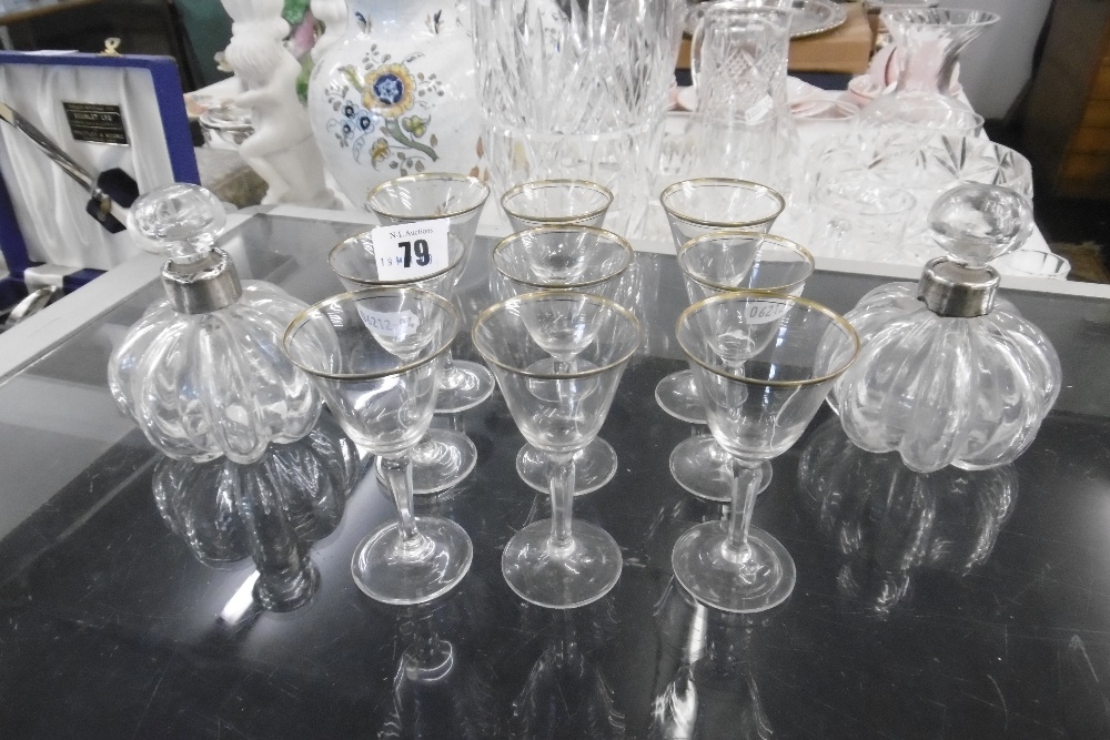 NINE GILT GLASSES AND A PAIR OF SCENT OF BOTTLES WITH WHITE METAL COLLARS (A/F)