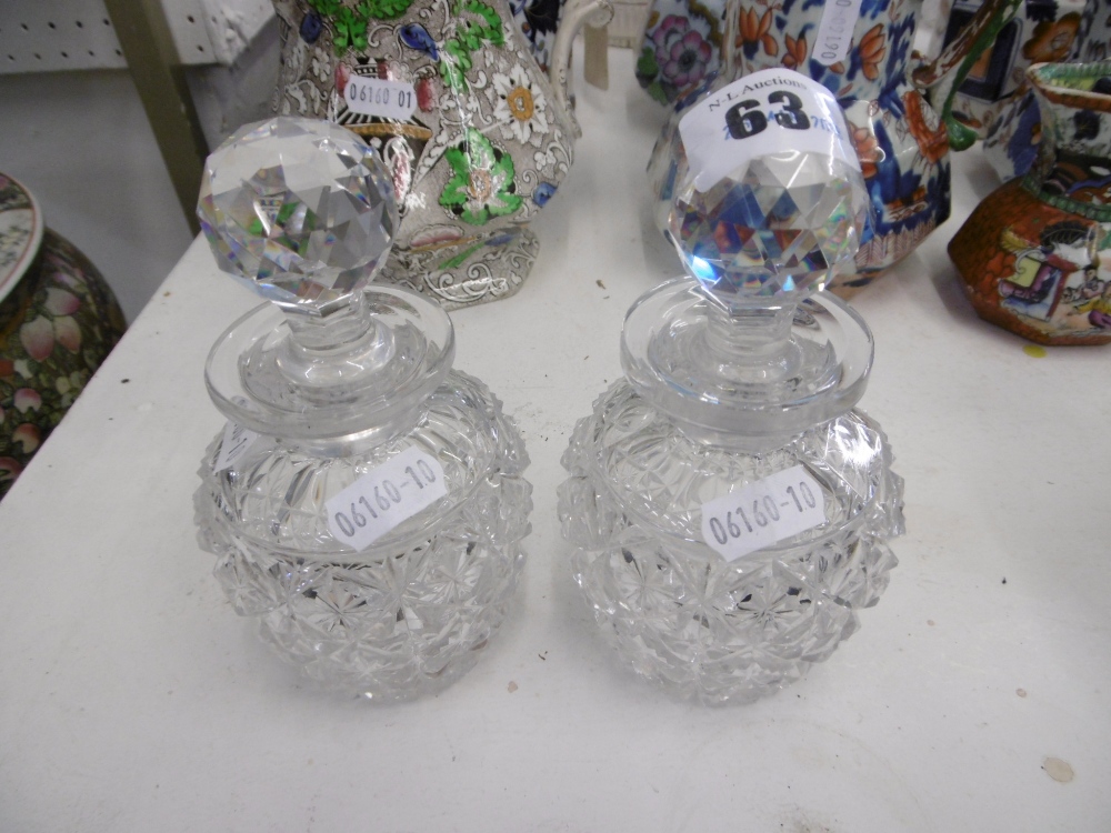 A PAIR OF CUT GLASS BOTTLES WITH STOPPERS