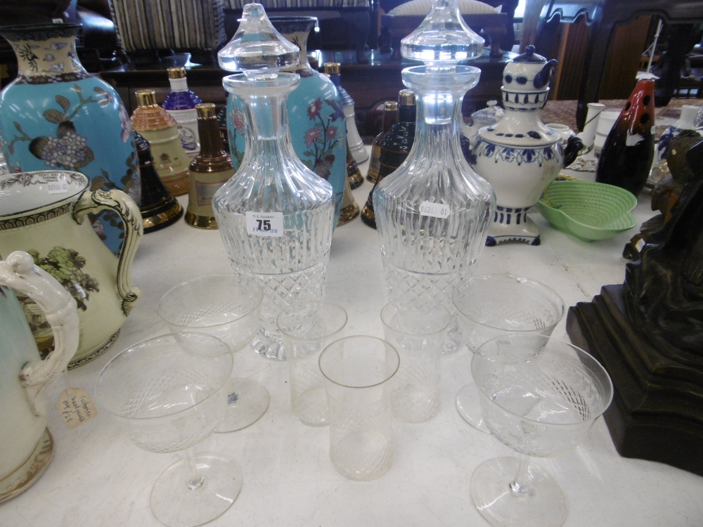 A PAIR OF CUT CRYSTAL DECANTERS AND A PART SUITE OF ETCHED GLASSES,