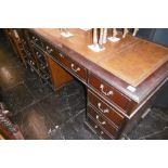 A MAHOGANY LEATHER TOPPED DESK