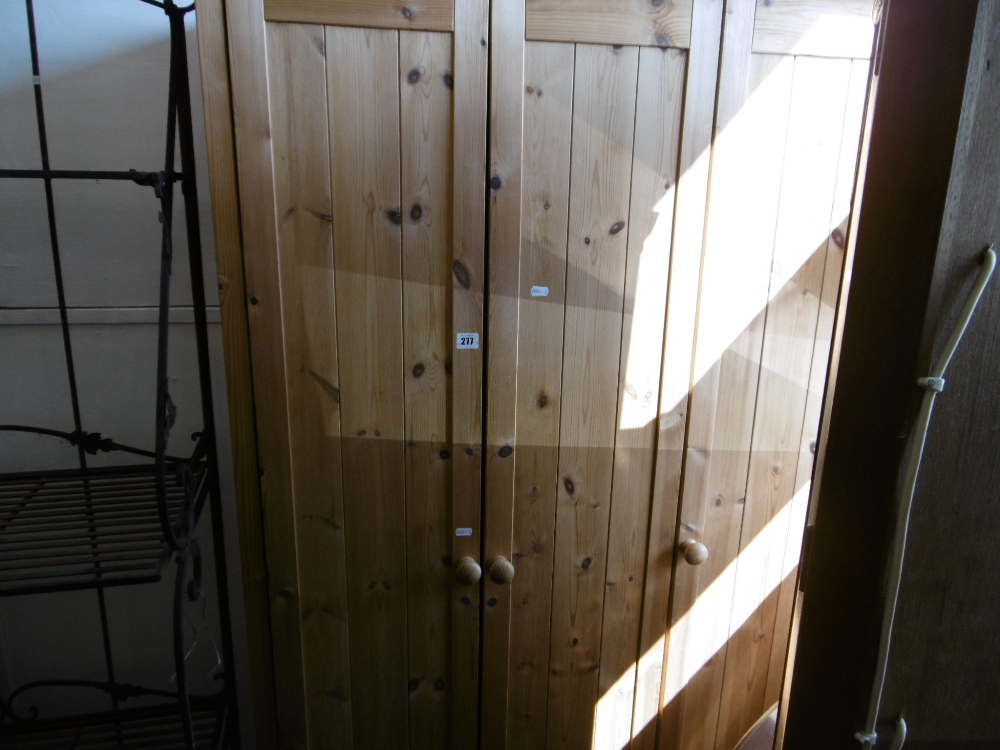 A PINE THREE DOOR WARDROBE