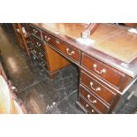 A MAHOGANY LEATHER TOPPED DESK