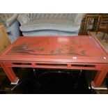 A RED LACQUERED COFFEE TABLE