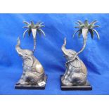 A PAIR OF SPELTER ELEPHANT CANDLESTICKS