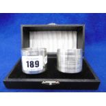 A PAIR OF ENGINE TURNED BOXED HALL MARKED SILVER NAPKIN RINGS