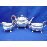 AN OLD SHEFFIELD PLATED THREE PIECE TEA SET ON LION PAW FEET