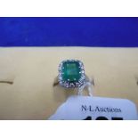 AN 18CT GOLD EMERALD AND DIAMOND RING