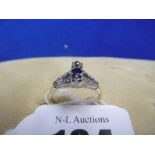 AN 18CT SAPPHIRE AND DIAMOND RING WITH DIAMOND SET SHOULDERS