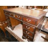 A MAHOGANY LEATHER TOPPED DESK