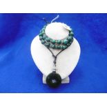 A SPINACH JADE NECKLACE AND A MALACHITE NECKLACE